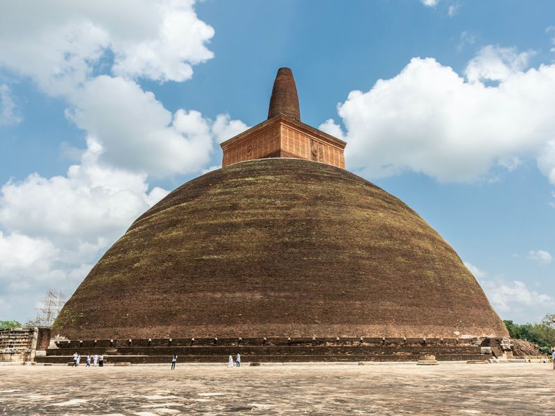 Anuradhapura is one of the best of Sri Lanka's historical places. This image shows the round Jetavanaramaya stupa with tourists at the base.